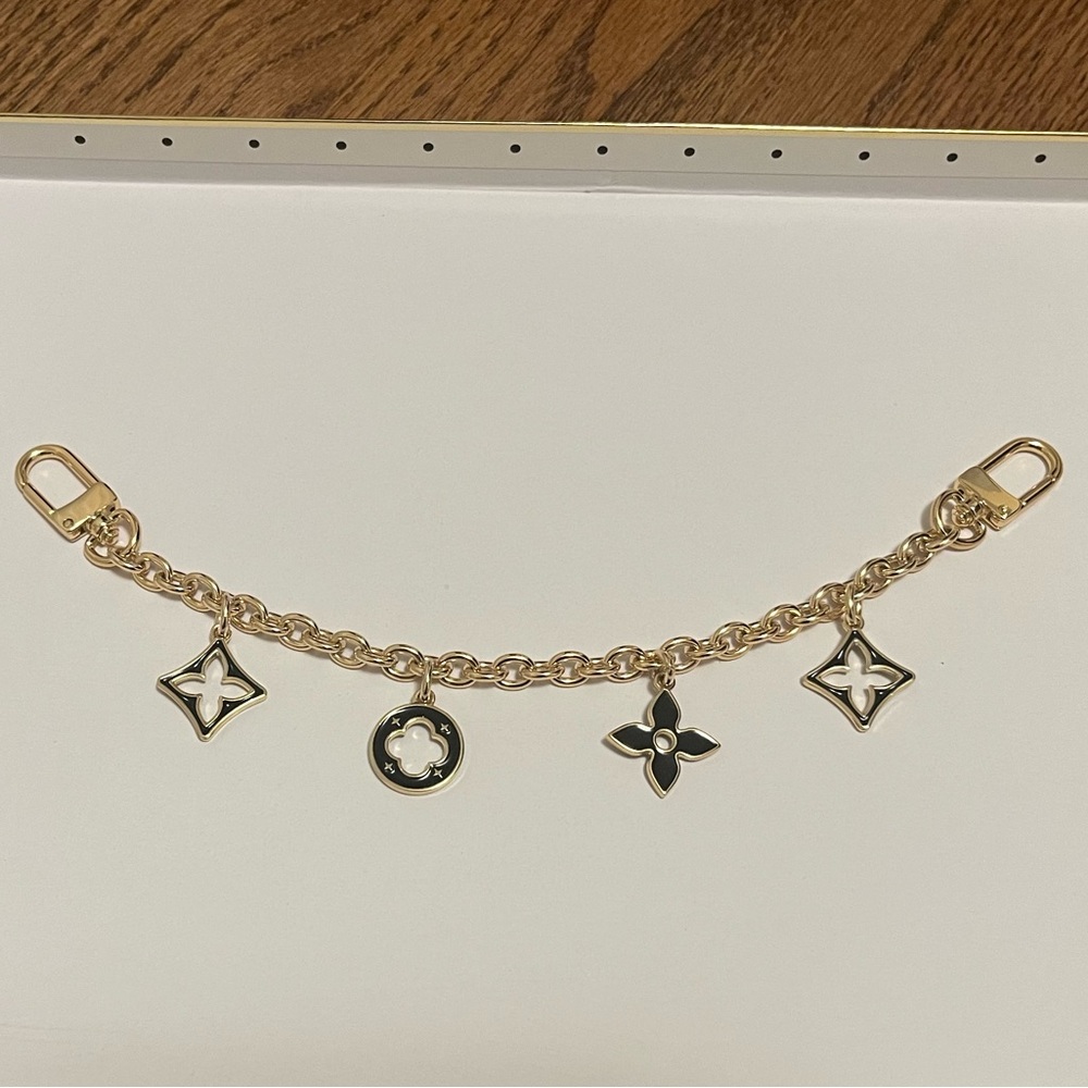 Black and gold bag charm